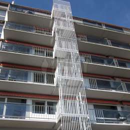 5 story fire escape cage ladder with decorative aluminium structure for balcony egress of an apartment building.