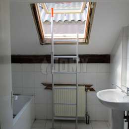 Fixed ladder with telescopic handle used to get out of a roof Velux window in a bathroom.